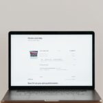 Minimalist laptop showing an online checkout screen on a white background, ideal for tech context.