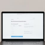 A laptop displaying an online checkout form, highlighting technology and e-commerce.