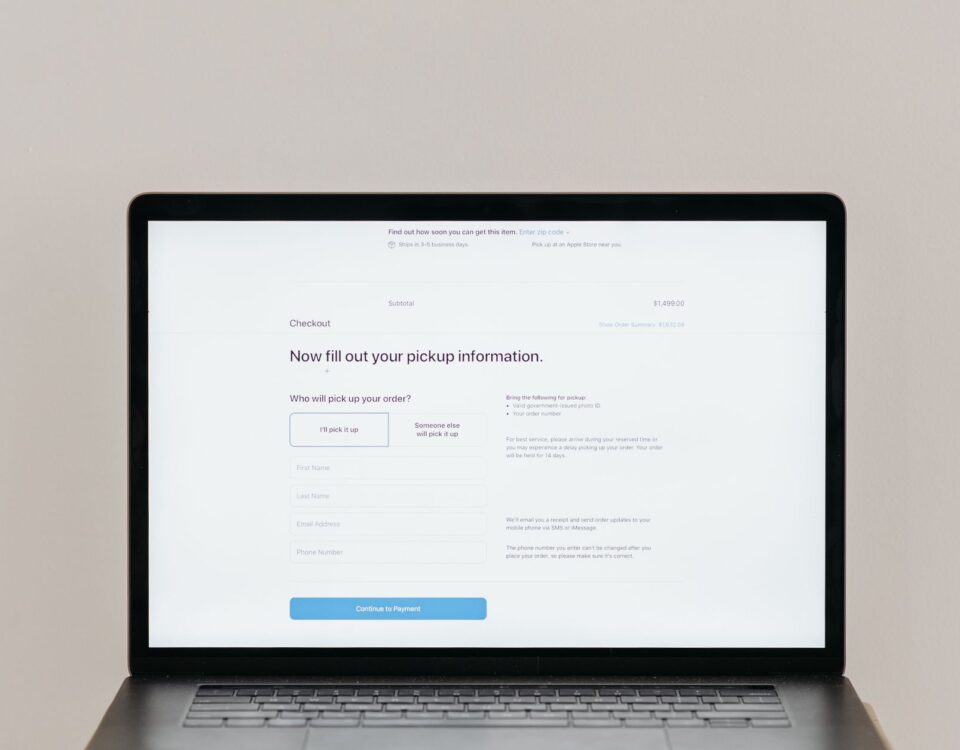 A laptop displaying an online checkout form, highlighting technology and e-commerce.