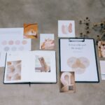 A flat lay of branding elements with color palettes and strategic planning documents on a concrete surface.