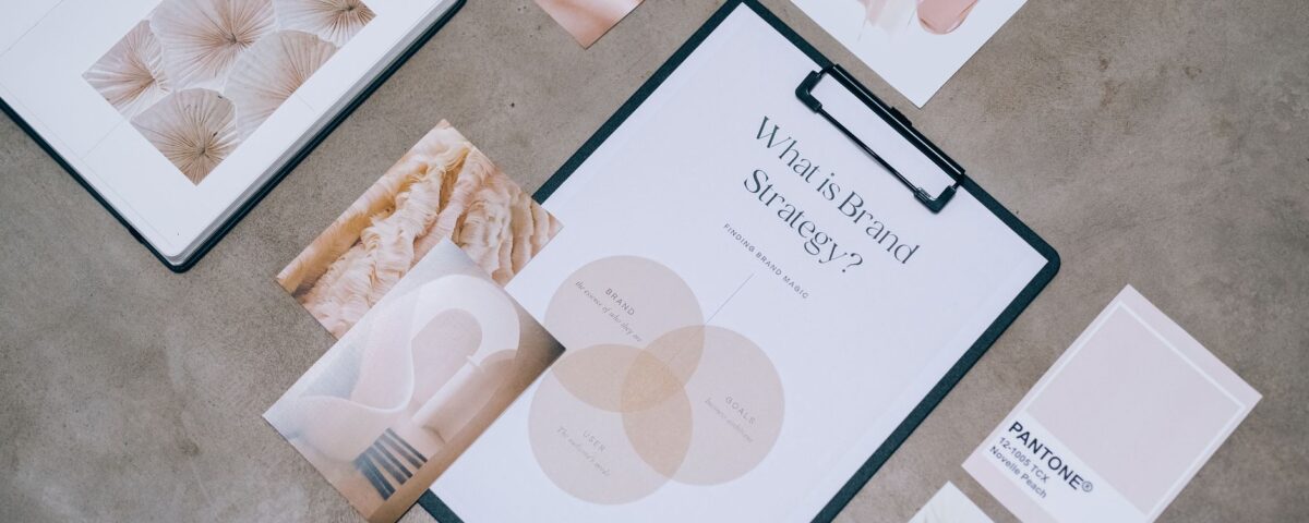 Flat lay showing branding materials and design concepts for creative strategy discussions.