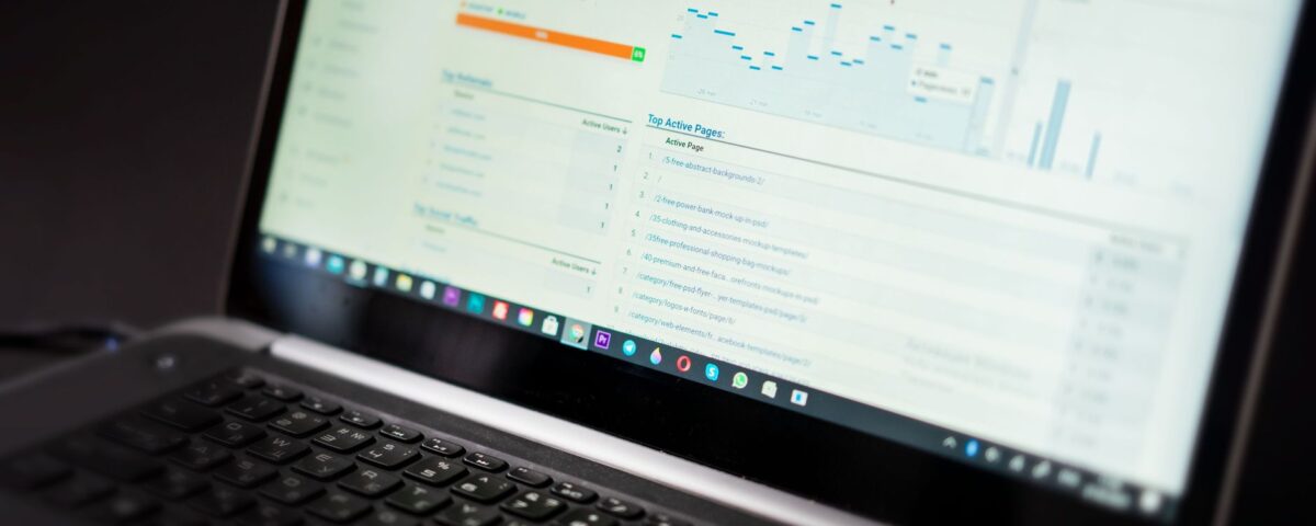 A laptop displaying an analytics dashboard with real-time data tracking and analysis tools.