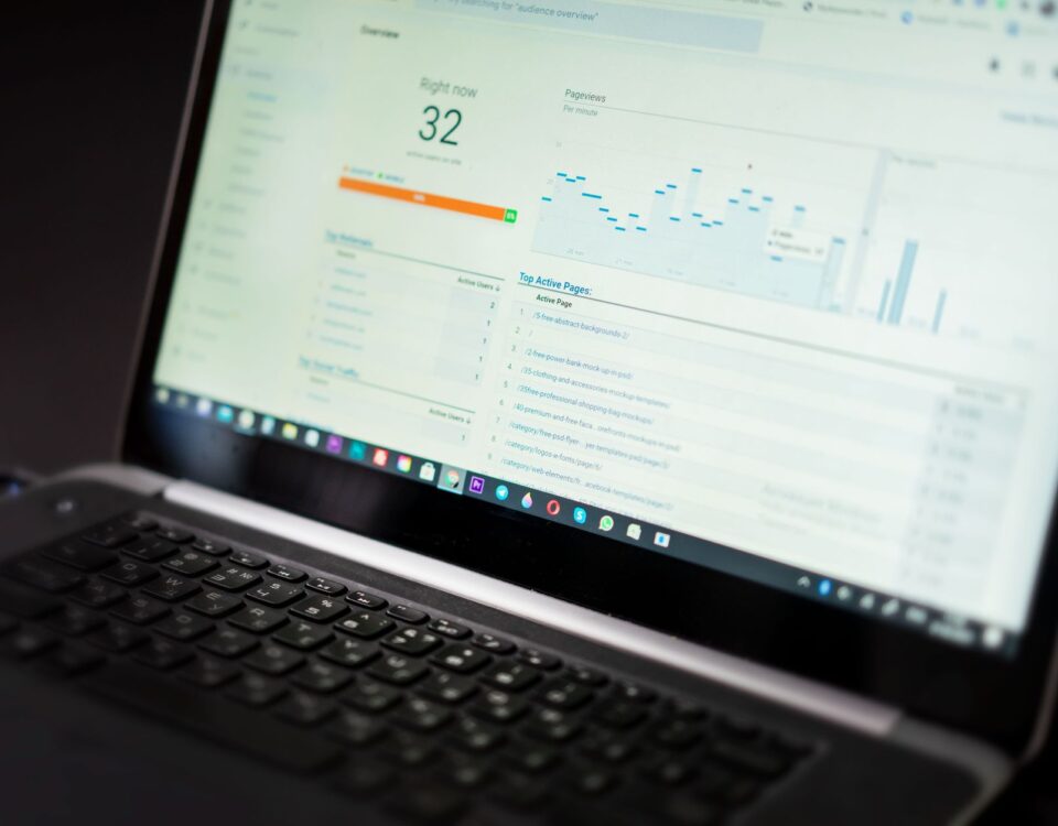 A laptop displaying an analytics dashboard with real-time data tracking and analysis tools.